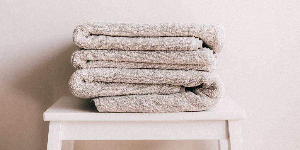 two folded towels on a chair