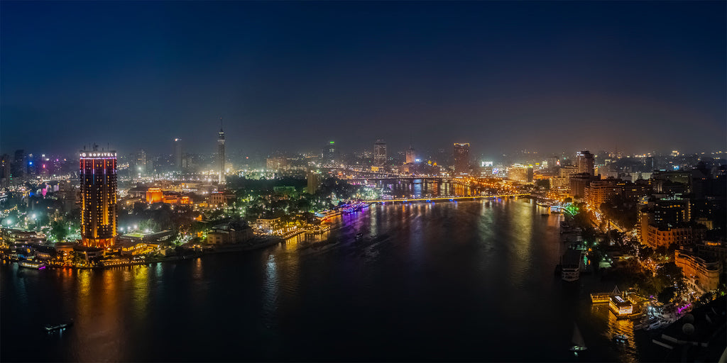 panorama photo for Cairo at night showing the Nile River