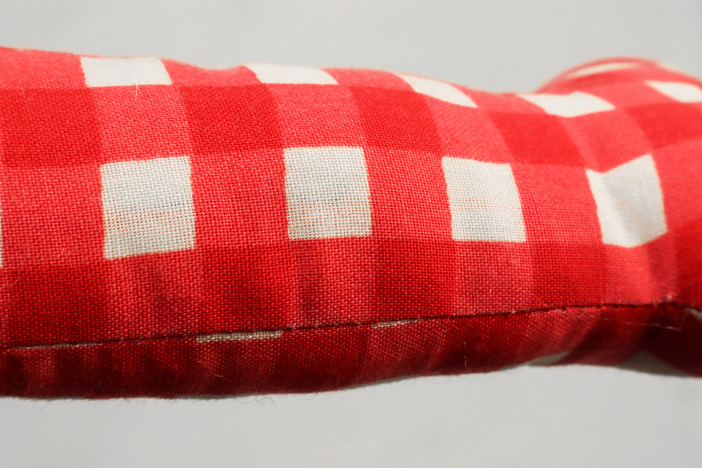 red and white patterns toy bone