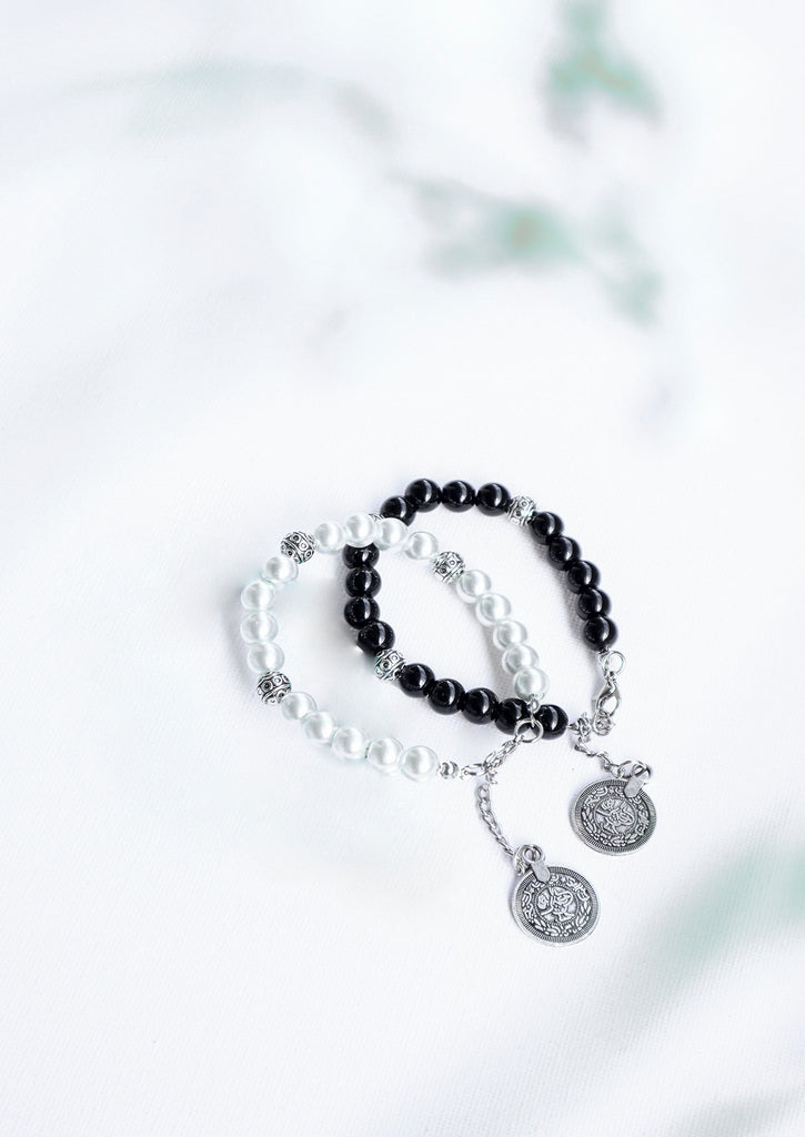 two gypsy coin bracelets on white background - black and white bracelets