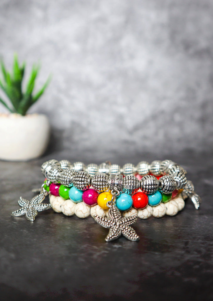 Candies Bracelet whit Starfish and cream marble bracelets- On a grey backdrop 