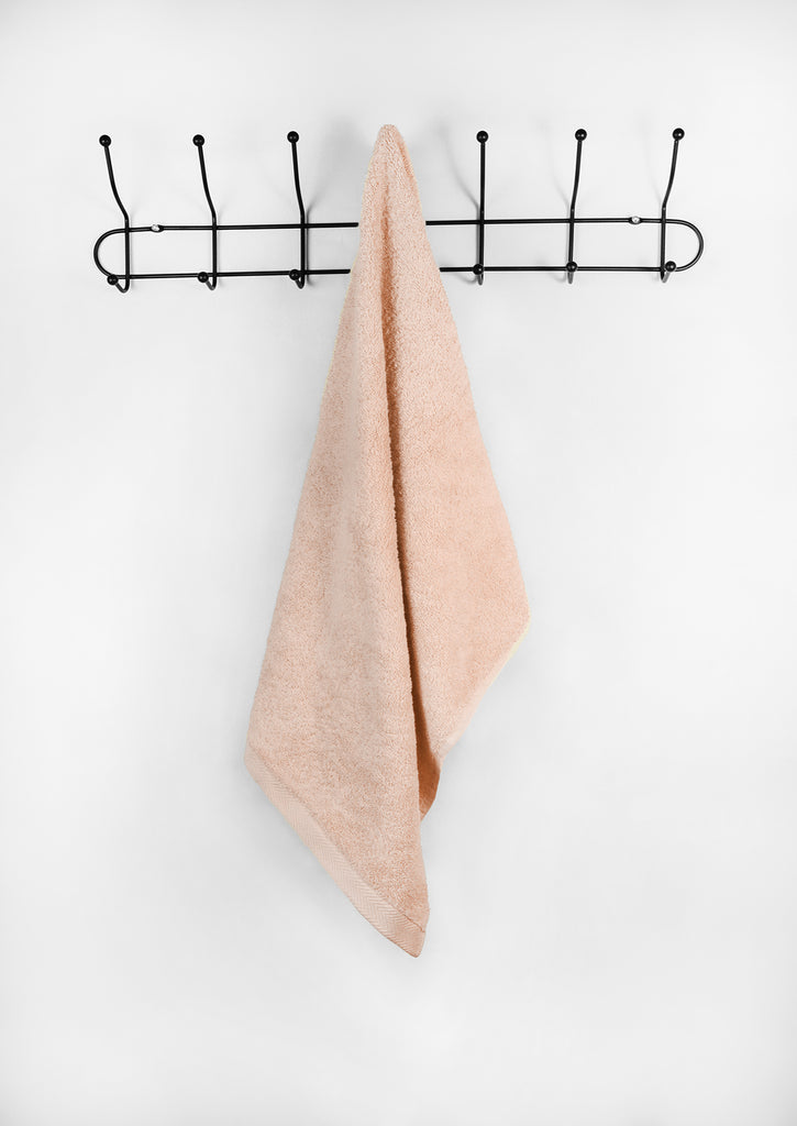 peach face towel on a hanger