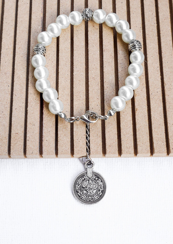 gypsy coin white bracelet on wooden tray