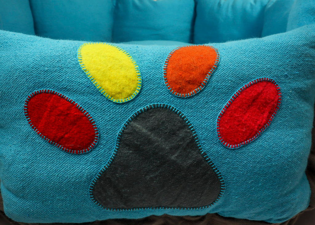 colourful paw stitched on doughnut bed