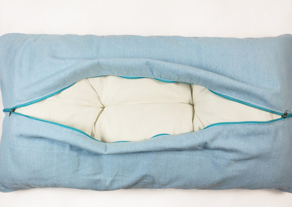 The cushion of cuddler bed on white background - opened zipper 