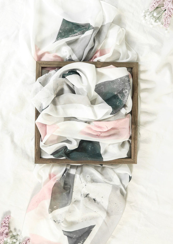 Marble Soft Hues Scarf in wooden frame on white bed with pink flowers