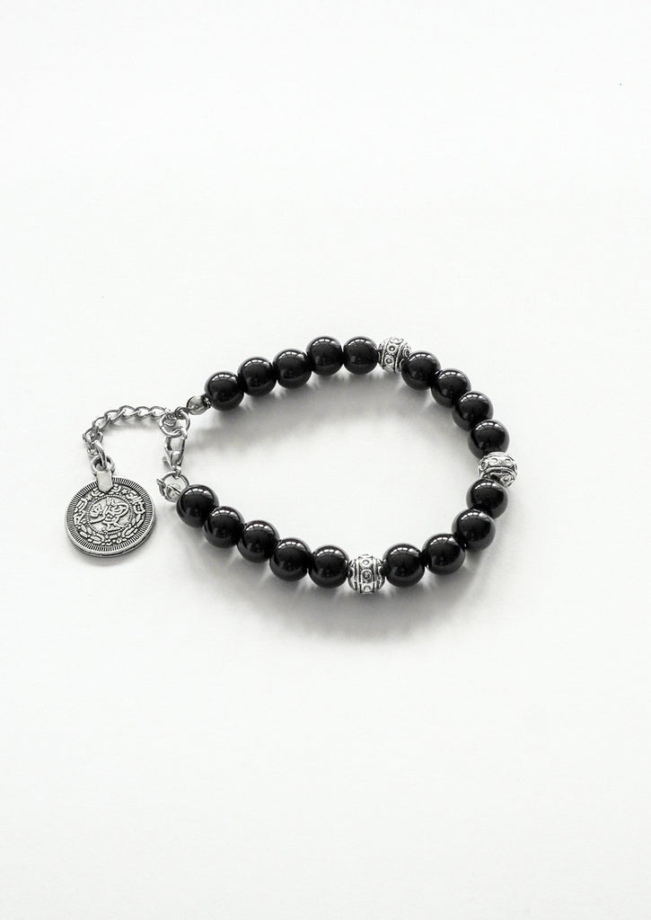 flat lay for gypsy coin black bracelet