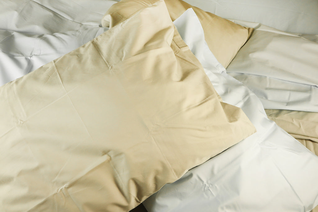 four messy pillow on a bed - silver beige duvet cover set