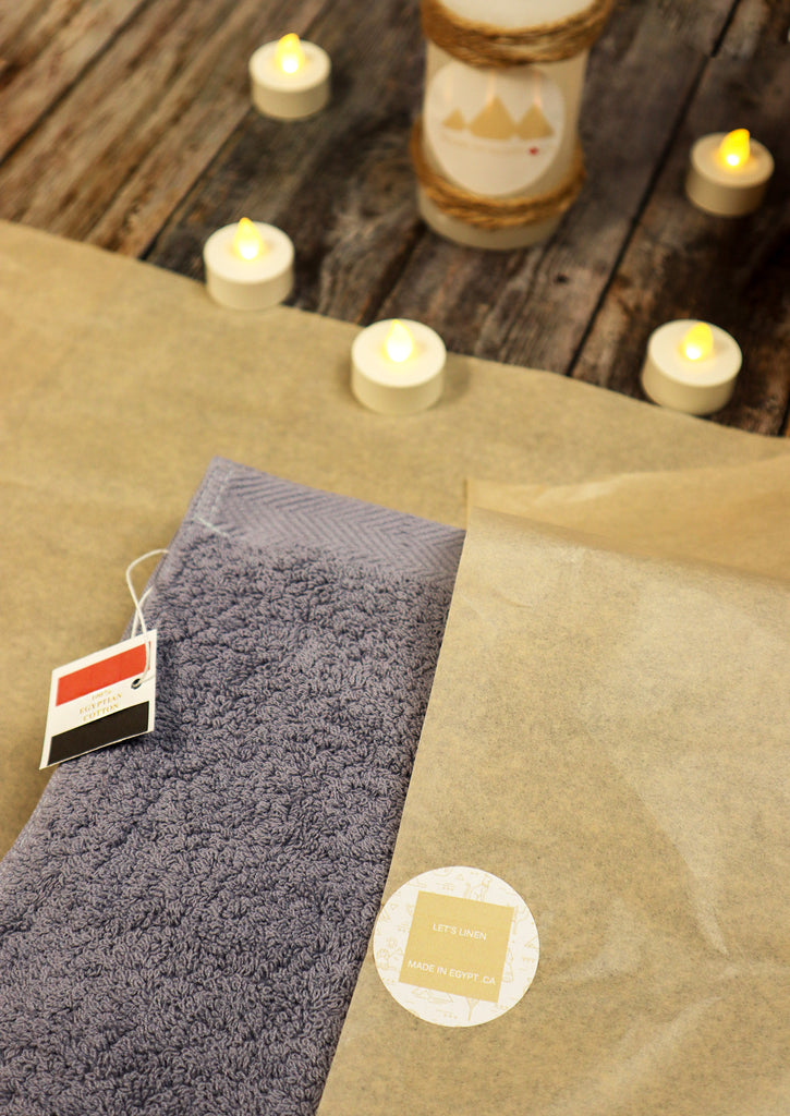 candles with half packaged anchor grey towel