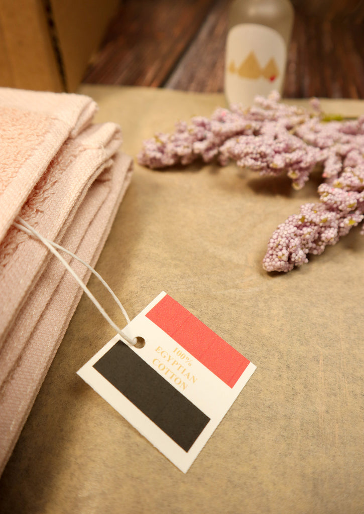 100% Egyptian Cotton label with some flower beside cloud pink towel