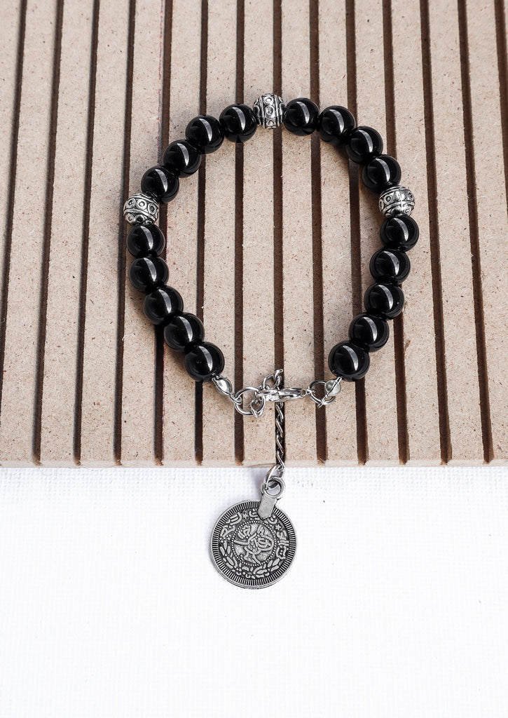 black gypsy coin bracelet on wooden tray