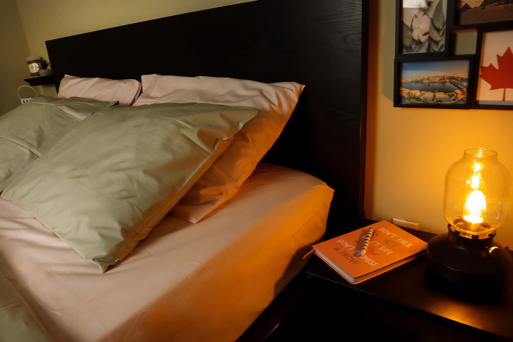 warm photo of a night stand and a bed with flamingo pink bed set