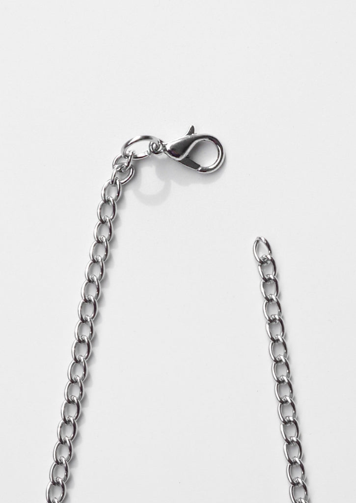 A lobster claw clasp attached to a chain - white background 