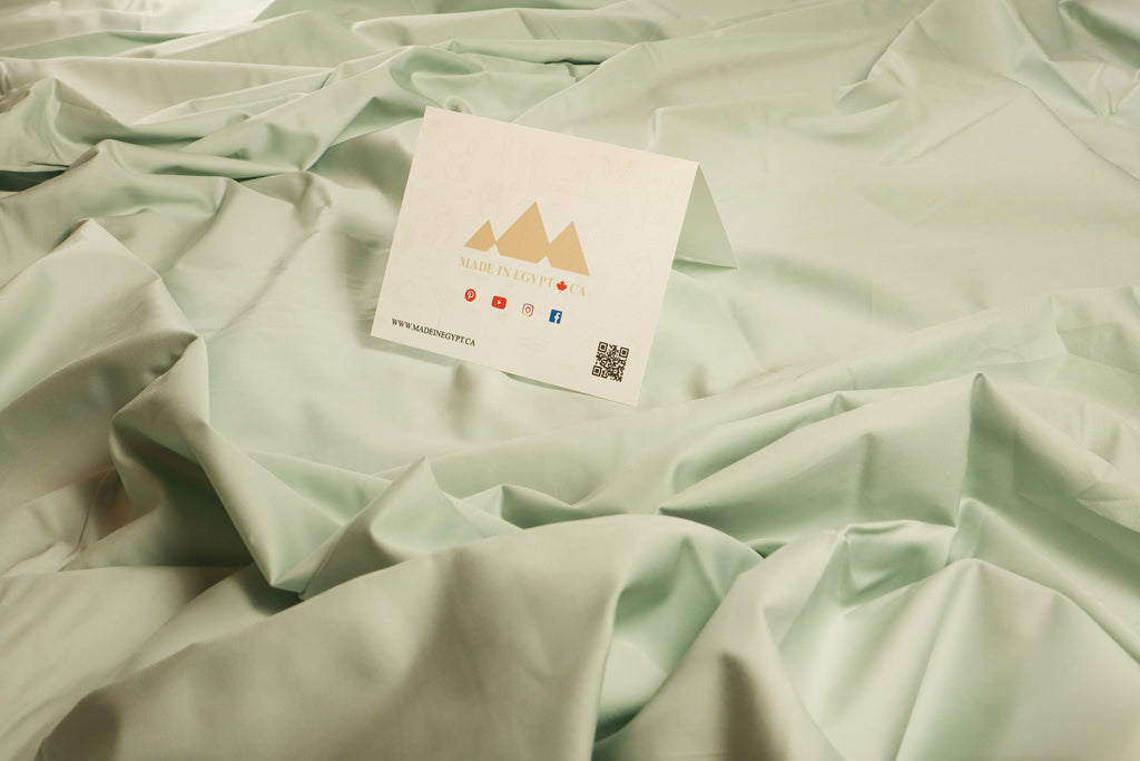 a bed note from MADE IN EGGYPT .CA on a messy sea salt flat sheet