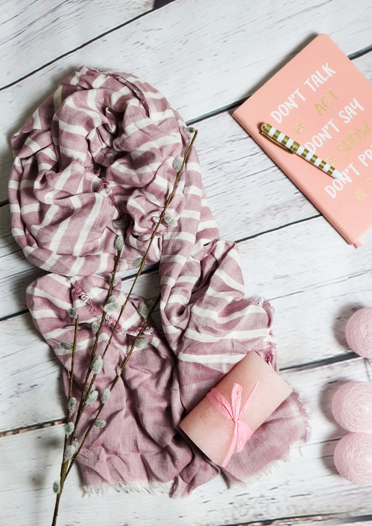 Blush Scarf with pink candle and pink notebook on grey background 