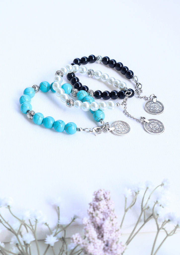 three gypsy coin bracelets on white background - black , white and turquoise